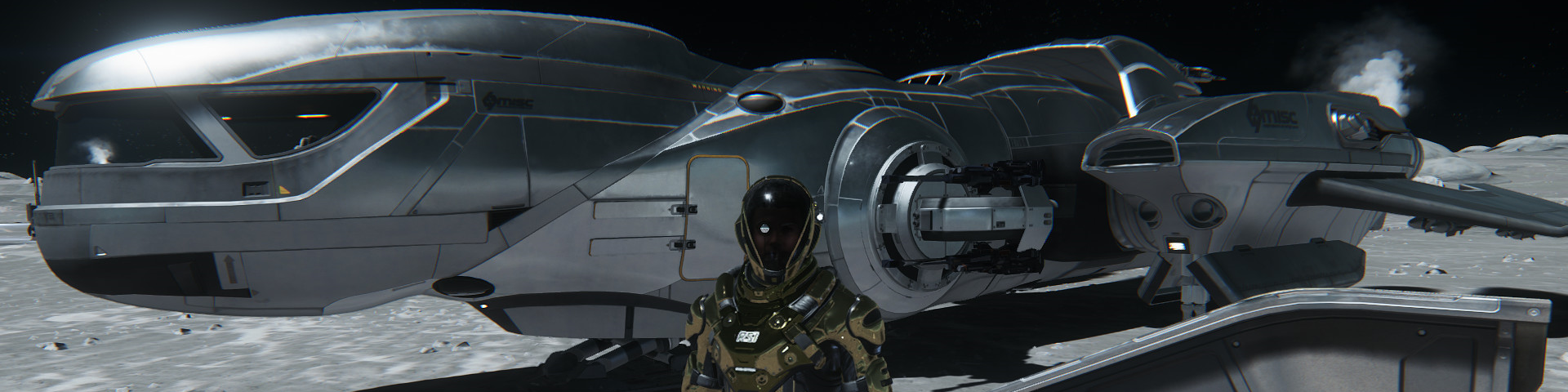 A man standing in front of a landed heavy shuttle.